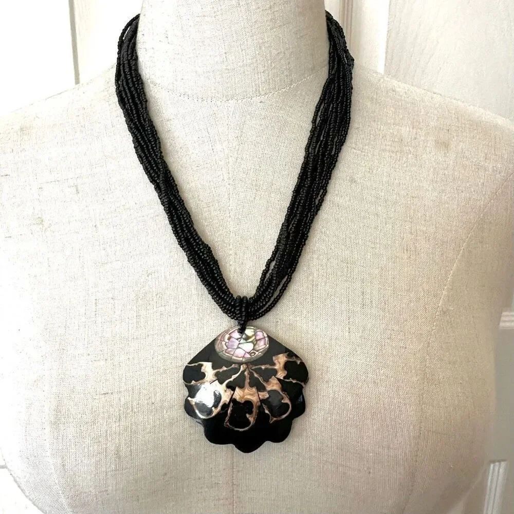 Abalone shell fan pendant on multi strand black beaded necklace